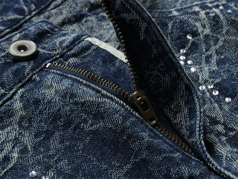 Close-up of zip fly and button closure on distressed blue jeans