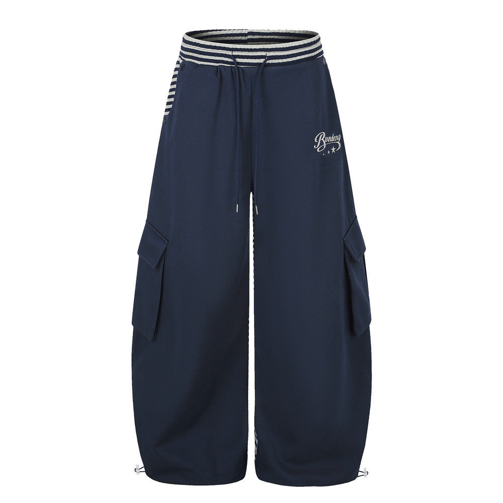Men's wide-leg cargo sweatpants with striped contrast waistband and flap pockets in navy blue and black