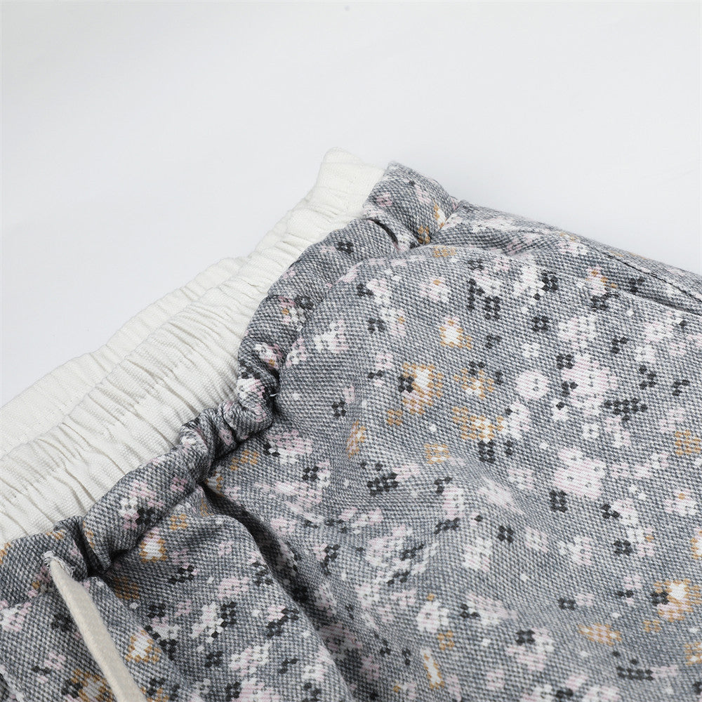 Close-up of waistband and floral print fabric with gathered elastic top edge