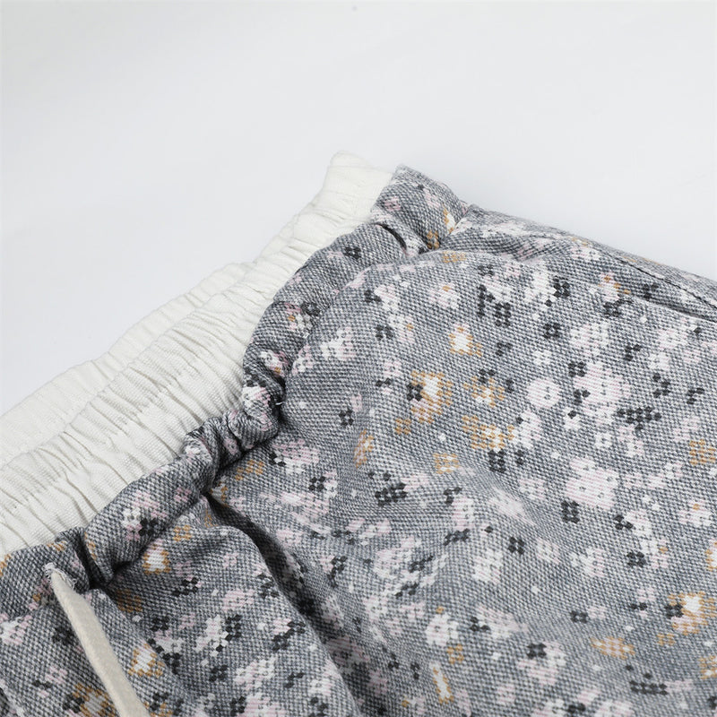Close-up of waistband and floral print fabric with gathered elastic top edge