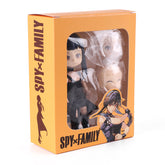 The orange box contains the Anya & Yor Forger Nendoroid Set, 13cm poseable anime figures from "Spy × Family," displaying characters through a plastic window. The front features the series name and an illustration of Anya and Yor in their iconic black outfits.