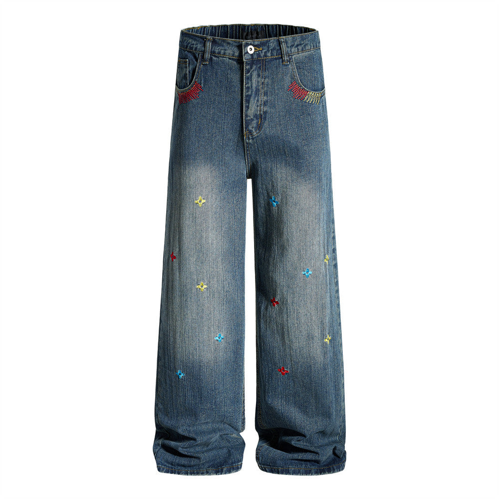 Wide-leg washed denim jeans with multicolor cross-star embroidery and rhinestone pocket detail in dark blue
