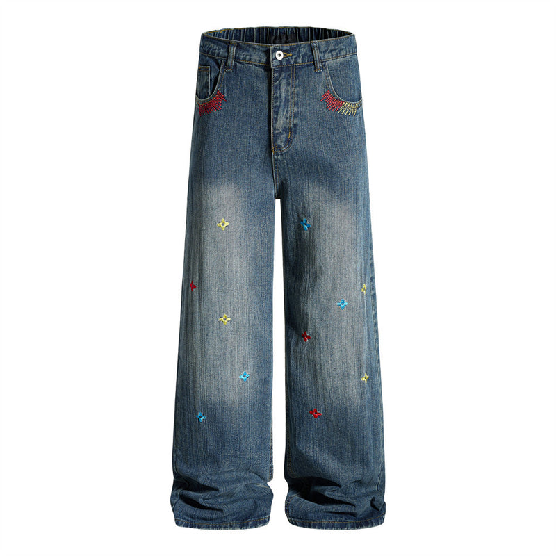 Wide-leg washed denim jeans with multicolor cross-star embroidery and rhinestone pocket detail in dark blue