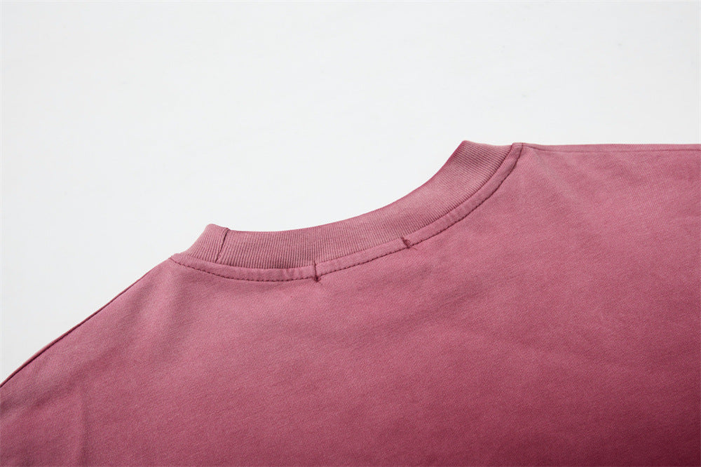 Close-up of crew neck collar on burgundy long sleeve shirt