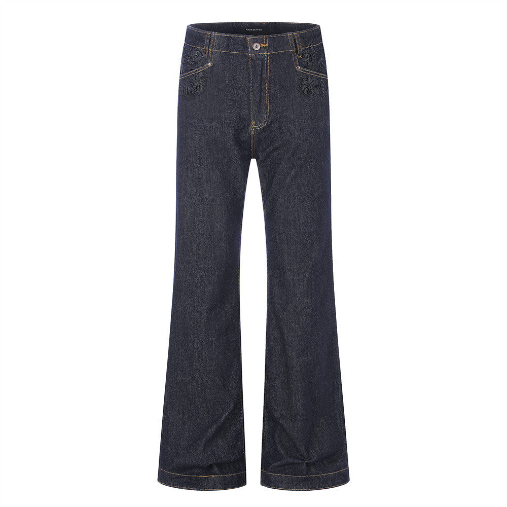 Dark indigo wide-leg flare jeans with embossed floral pocket detail and gold topstitching, front and back view
