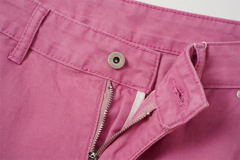 Close-up of rose pink shorts front fly with zipper and button waistband