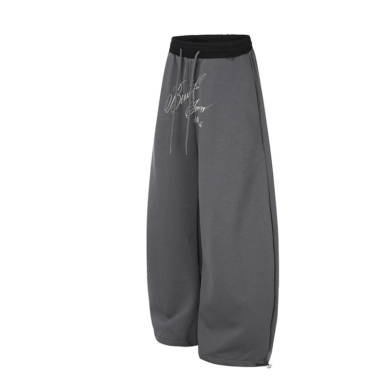 Pantalon de survêtement large à inscription et ceinture contrastante