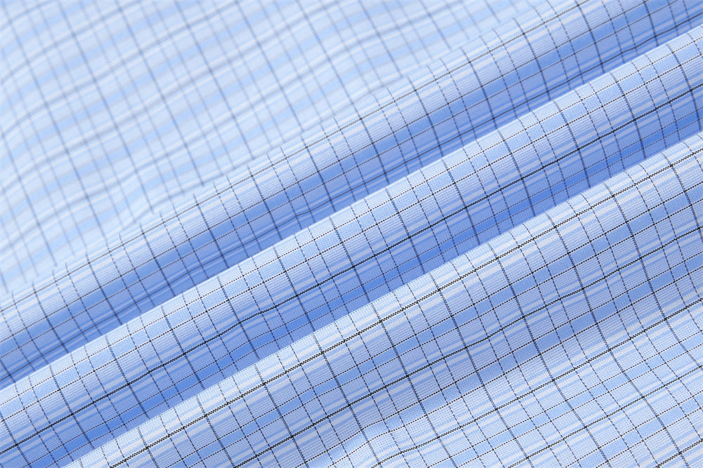 Light blue plaid fabric close-up with fine check pattern