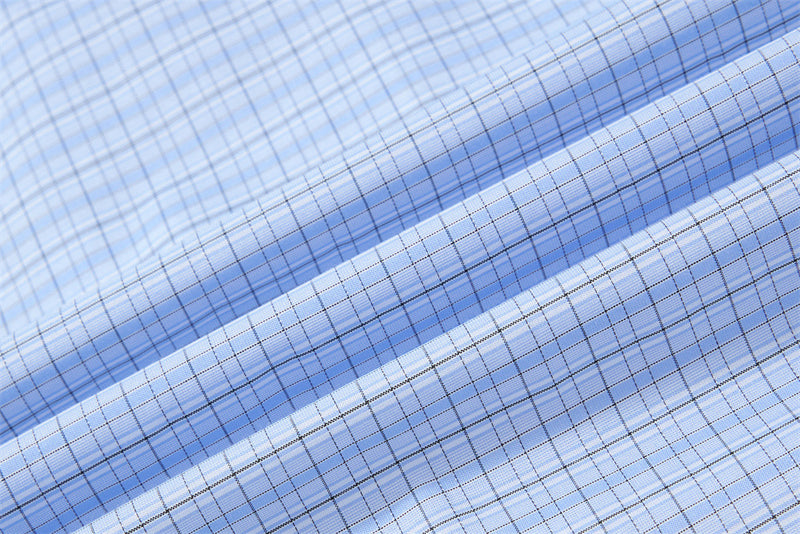 Light blue plaid fabric close-up with fine check pattern