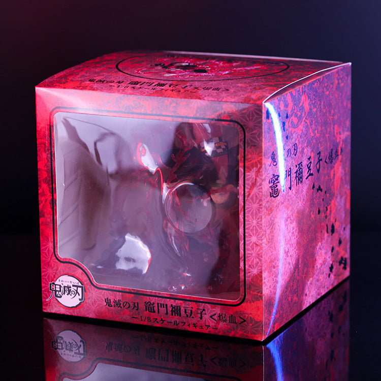 The Demon Slayer Nezuko Explosion Pose figure is showcased in a red and black decorative box with floral patterns and Japanese text, featuring a clear window for partial visibility against a dark background—perfect for any collection.