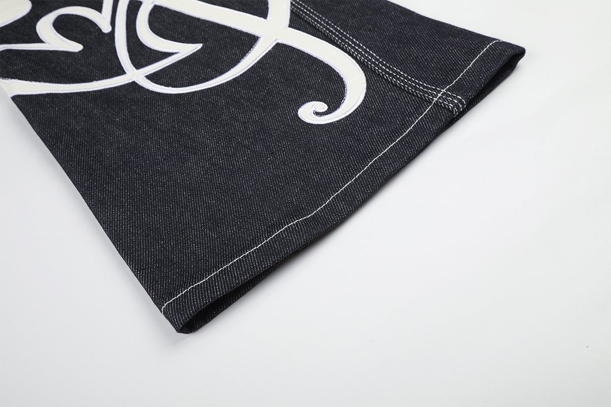Jean baggy à jambes larges avec broderies et patch en cuir motif notes de musique — Denim noir brut