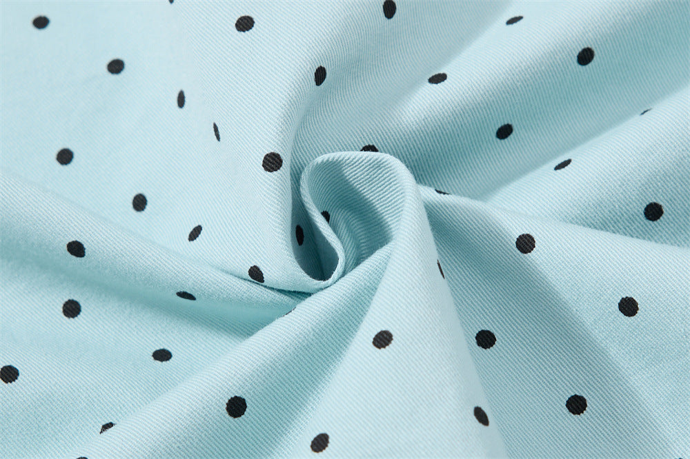 Close-up of light blue polka dot fabric gathered into a swirl