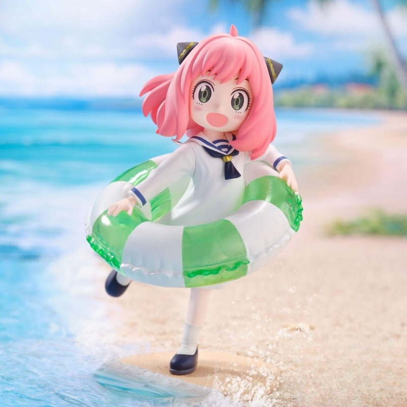 The Anya Forger Swimming Figure from Spy × Family is a 10cm PVC anime collectible featuring a chibi-style character with pink hair and cat-ear accessories, wearing a sailor outfit and holding an inflatable swim ring amidst ocean waves and palm trees. Perfect for collectors!.