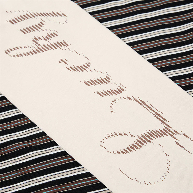 Close-up of cream sleeve with script print under black striped short sleeve