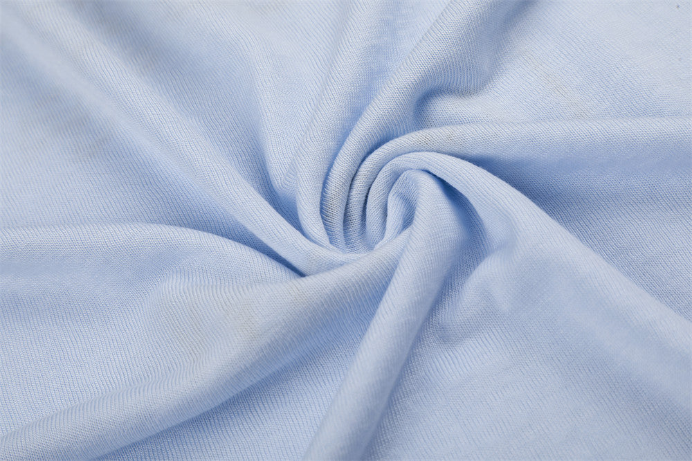 Close-up of light blue knit fabric gathered into a swirl