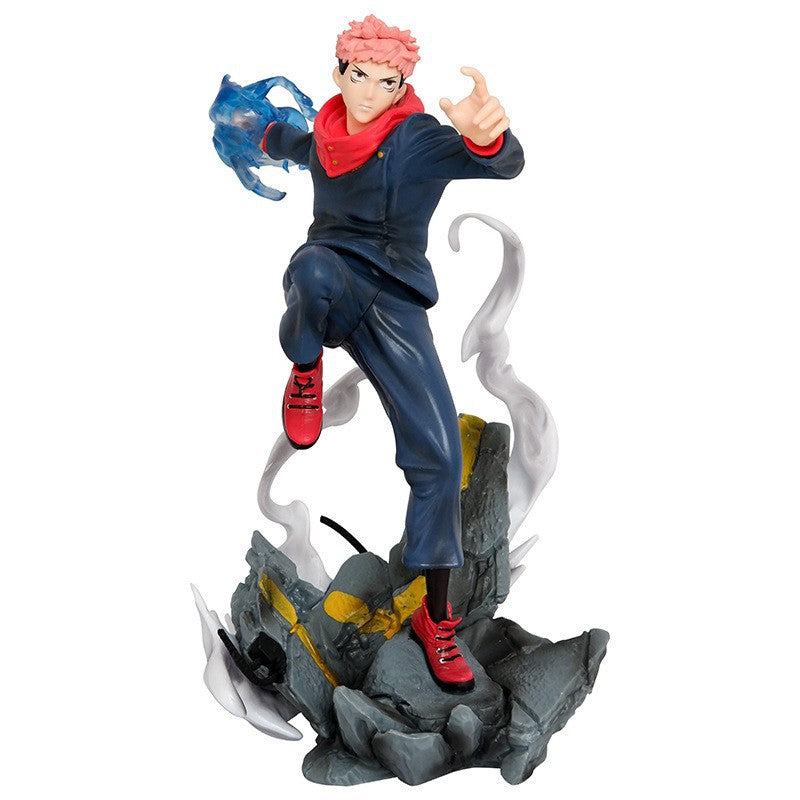 The Jujutsu Kaisen Yuji Itadori PVC Figure is a 24 cm collectible statue featuring an action pose with blue cursed energy effects, a dark blue outfit with a red collar and shoes, pink hair, and a rock-like base.