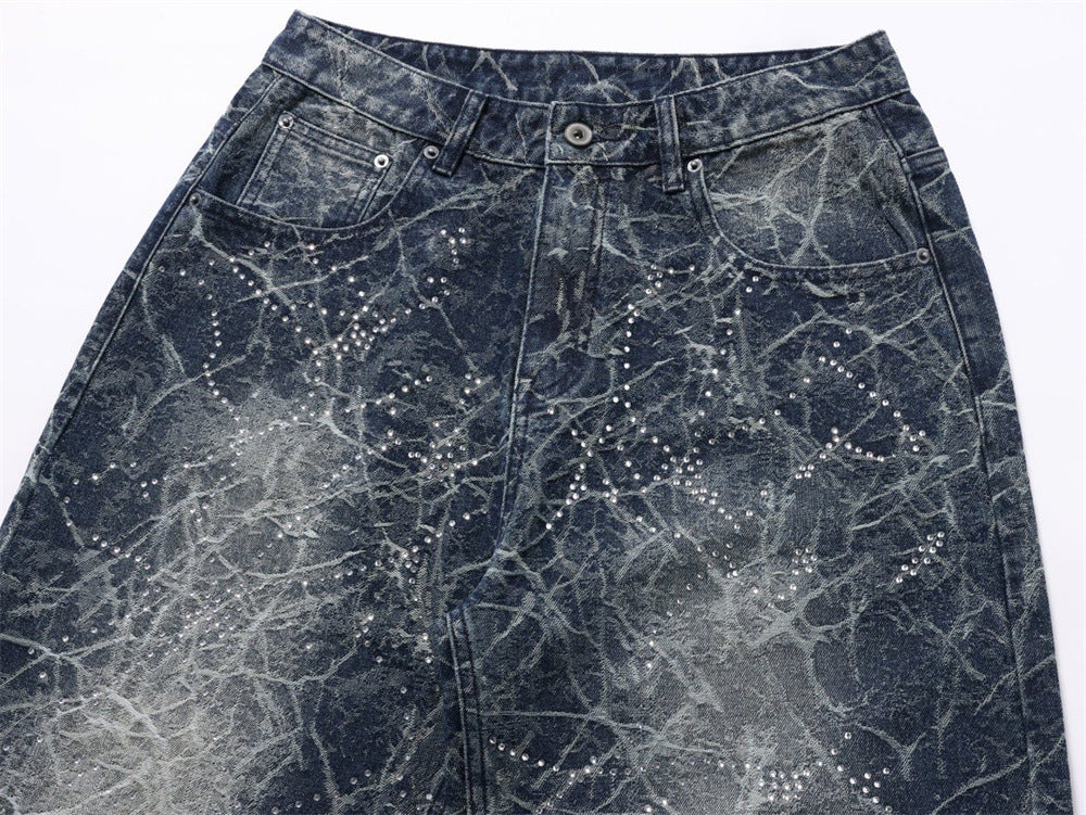 Close-up of front waistband and pockets on distressed denim with rhinestone dots