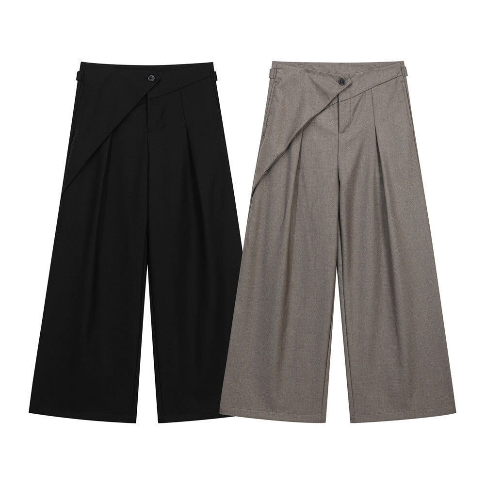Wide-leg pleated trousers with asymmetric wrap waist panel in black and taupe grey, front view