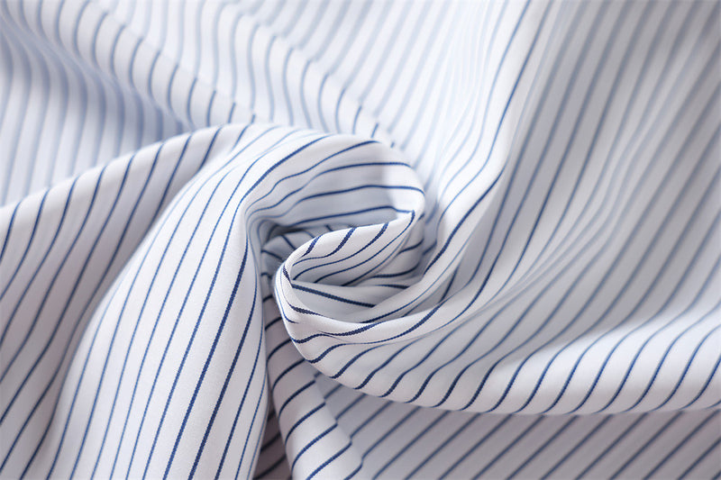 Close-up of gathered blue and white striped shirt fabric texture