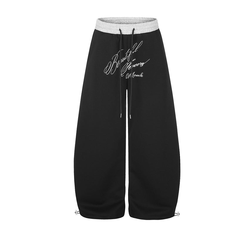 Pantalon de survêtement large à inscription et ceinture contrastante