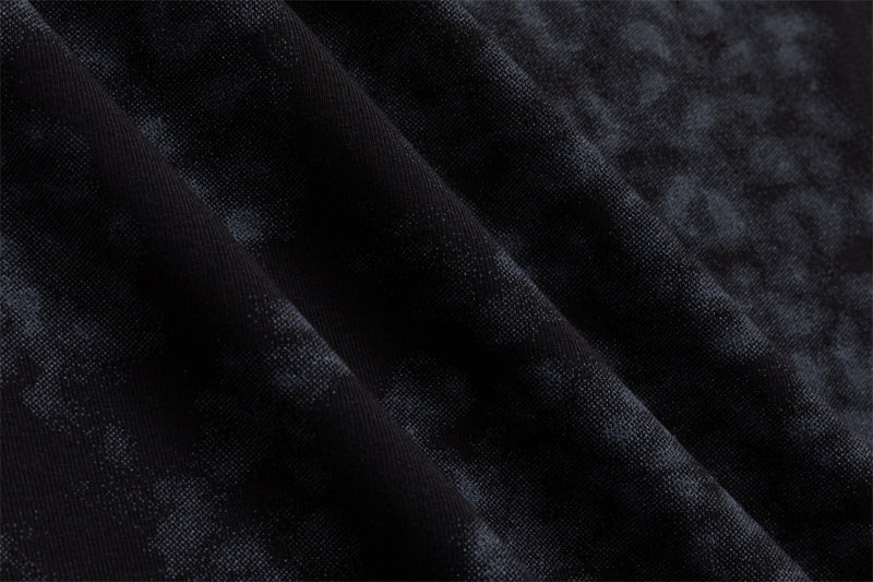 Close-up of the dark blue-black fabric showing its soft mottled pattern and fine textured surface