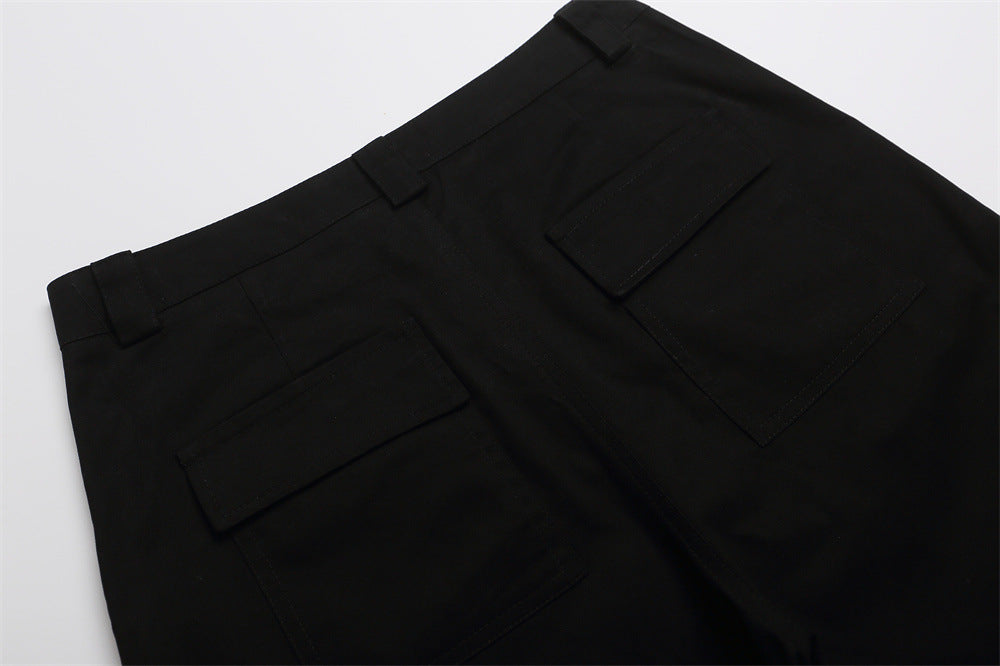 Close-up of black shorts back with belt loops and flap pockets