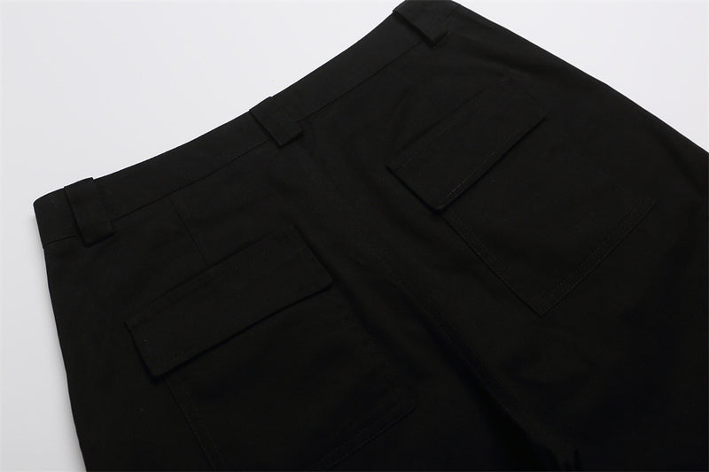 Close-up of black shorts back with belt loops and flap pockets