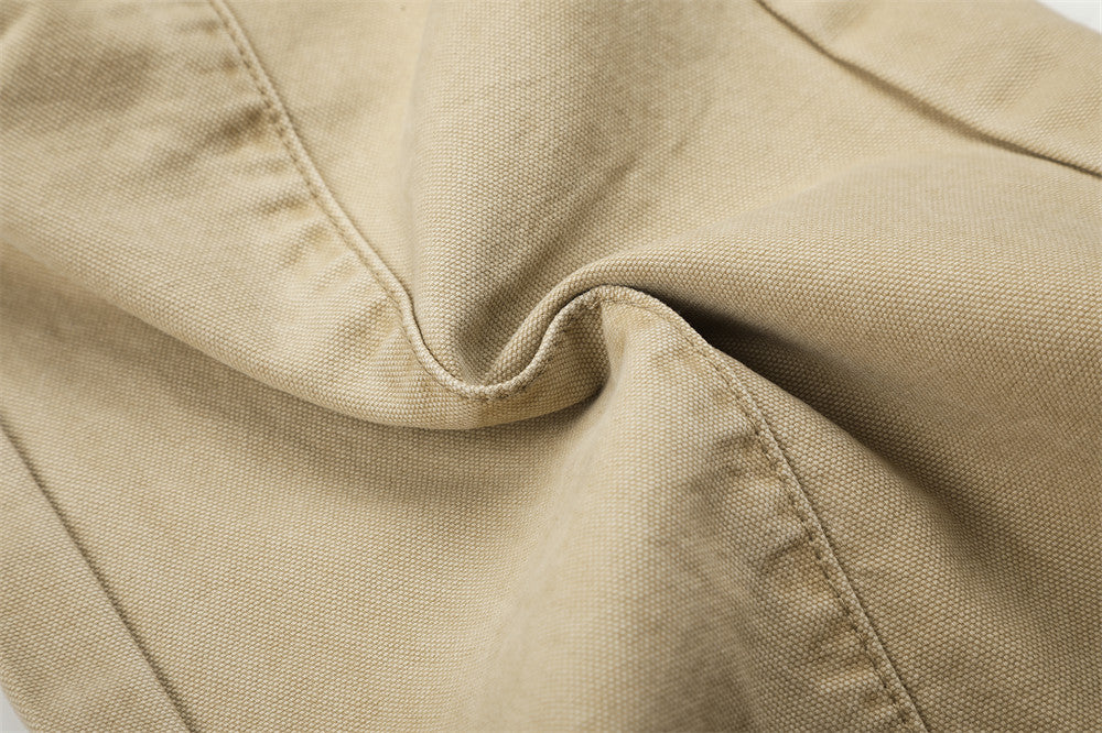 Close-up of beige cargo pants fabric texture with folded seam detail
