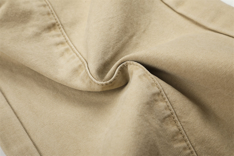 Close-up of beige cargo pants fabric texture with folded seam detail