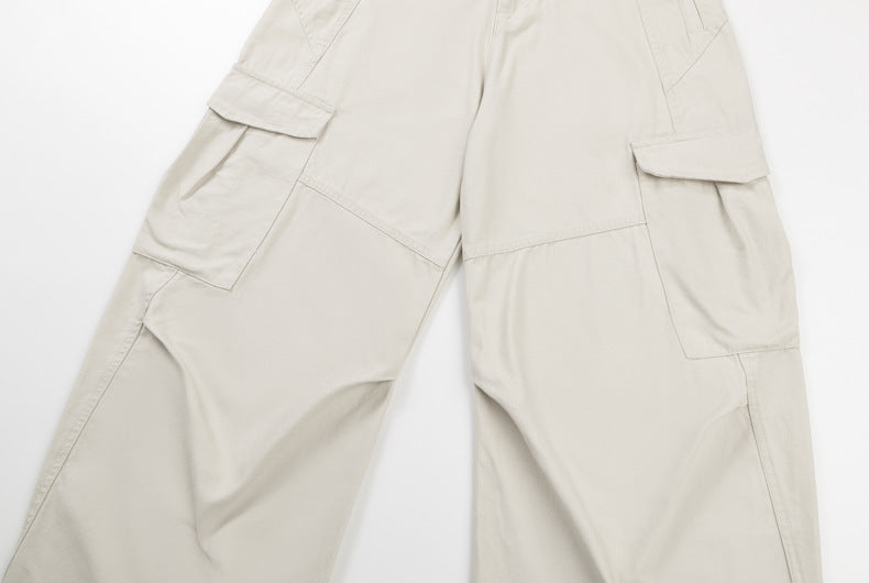 Cream cargo pants front with large flap pockets and wide legs