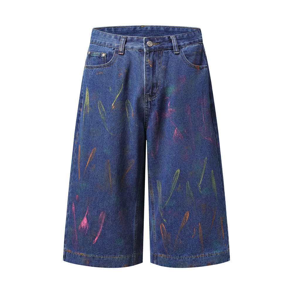 Wide-leg hand-painted graffiti denim shorts in light blue and dark blue wash with multicolor neon brushstroke print