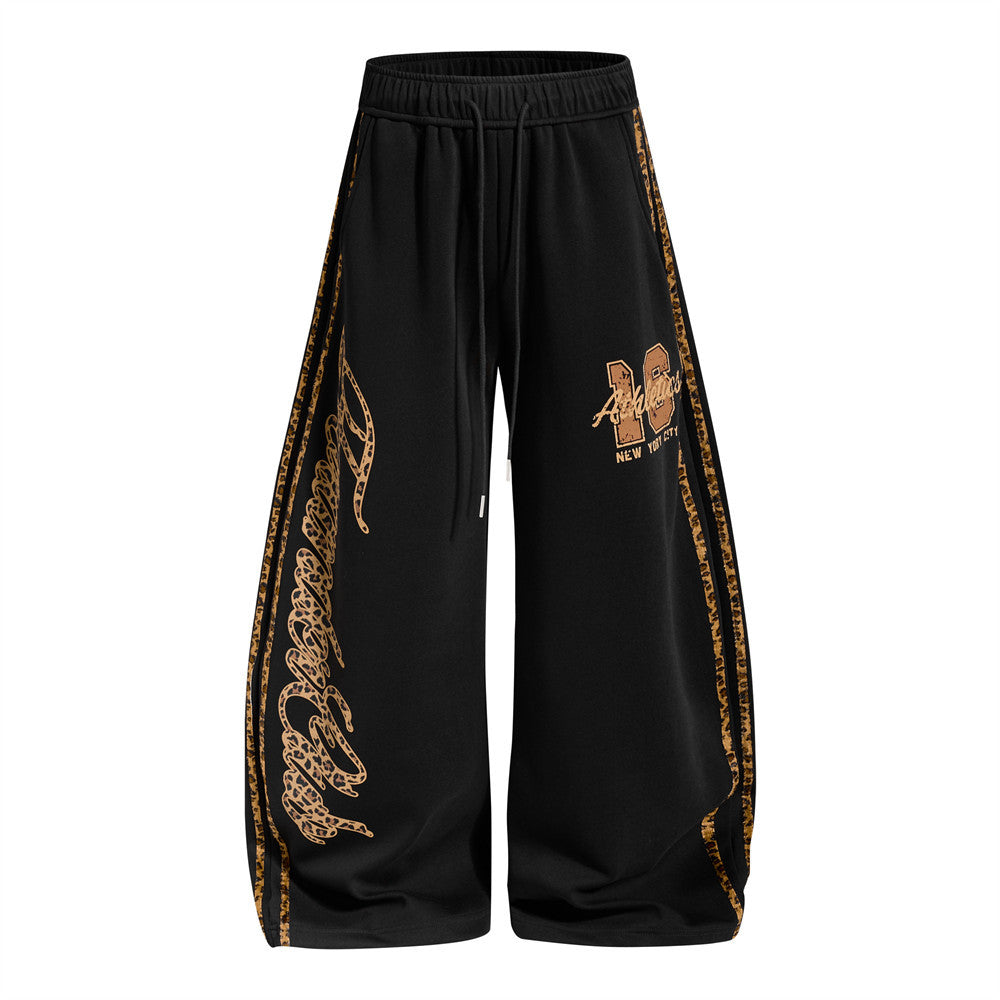 Men's wide-leg sweatpants with leopard print side panels and varsity graphic in black and yellow