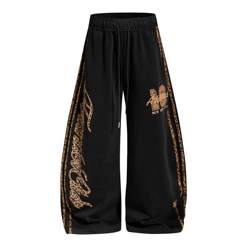 Men's wide-leg sweatpants with leopard print side panels and varsity graphic in black and yellow