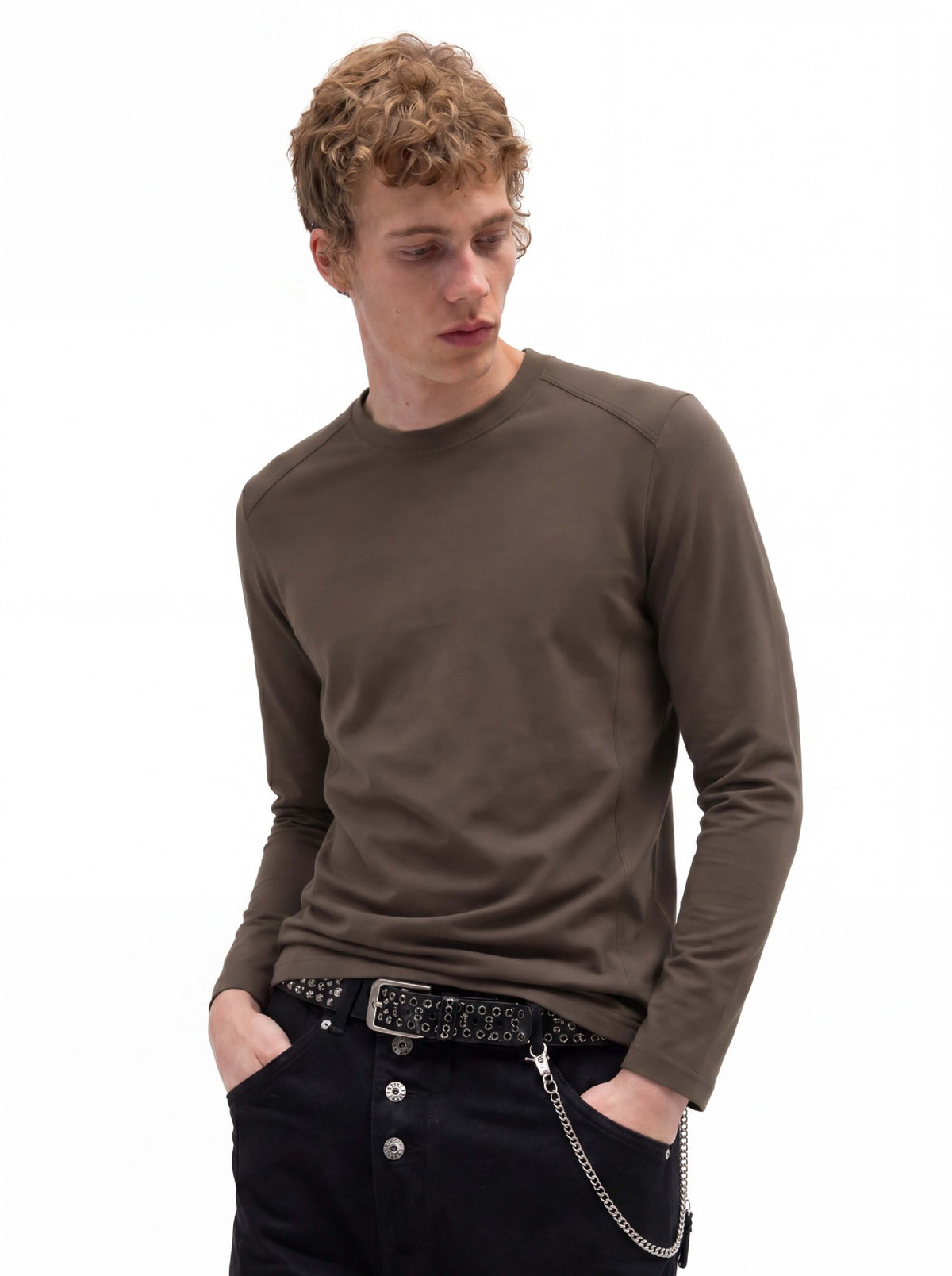 Men's slim fit long sleeve crew neck t-shirt in olive brown, worn with black jeans and a chain belt