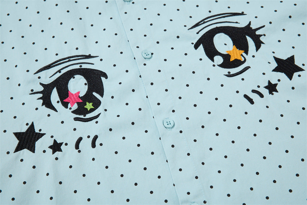 Close-up of the light blue shirt front with both anime eyes and black polka dot print