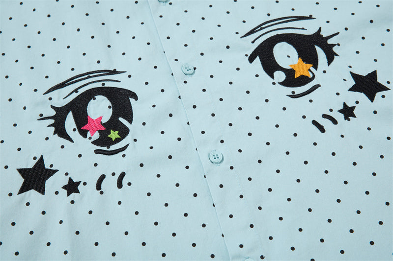 Close-up of the light blue shirt front with both anime eyes and black polka dot print