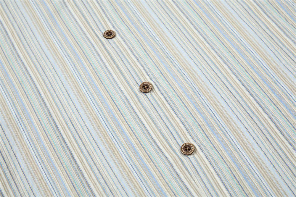 Close-up of striped shirt front with three brown buttons