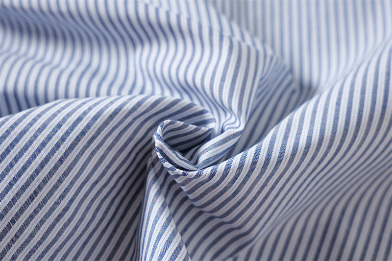 Close-up of blue and white striped fabric gathered in folds
