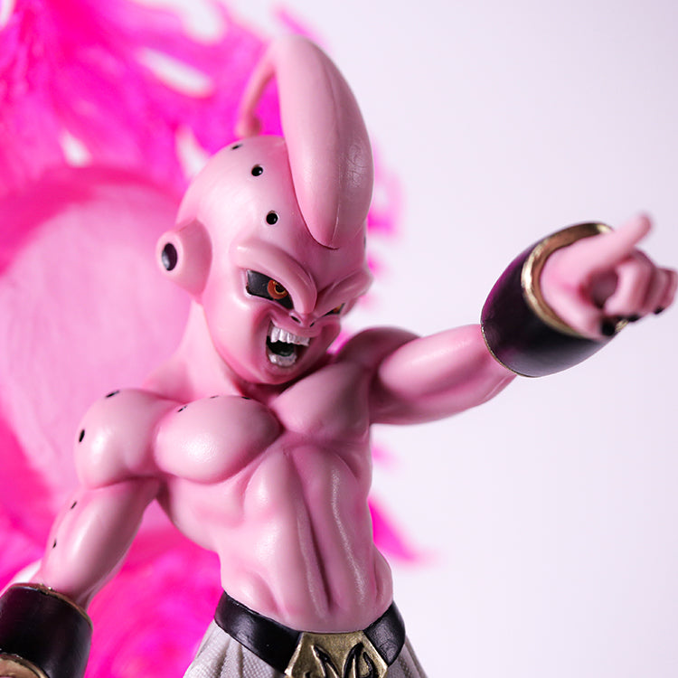 The Seakoff Majin Buu Collectible Figure from Dragon Ball Z, measuring 37cm, showcases a pink muscular form with a pointed head and black spots. It features a fierce expression in a dynamic pose, right arm extended within a glowing pink aura against a textured backdrop.