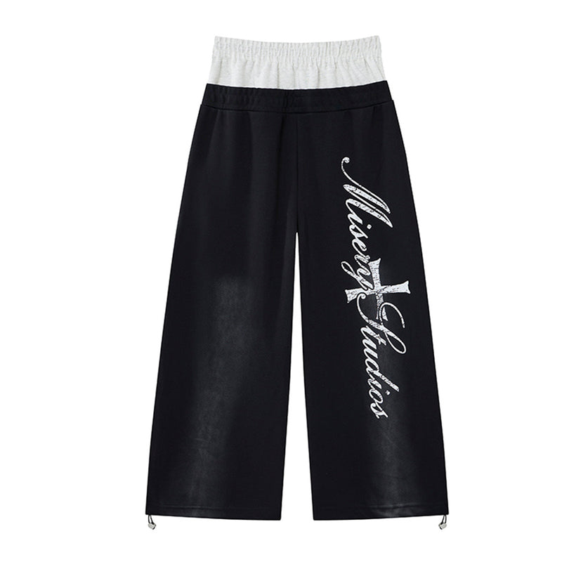 Pantalon de survêtement ample à jambes larges avec bandes latérales, fausse double ceinture et imprimé graphique