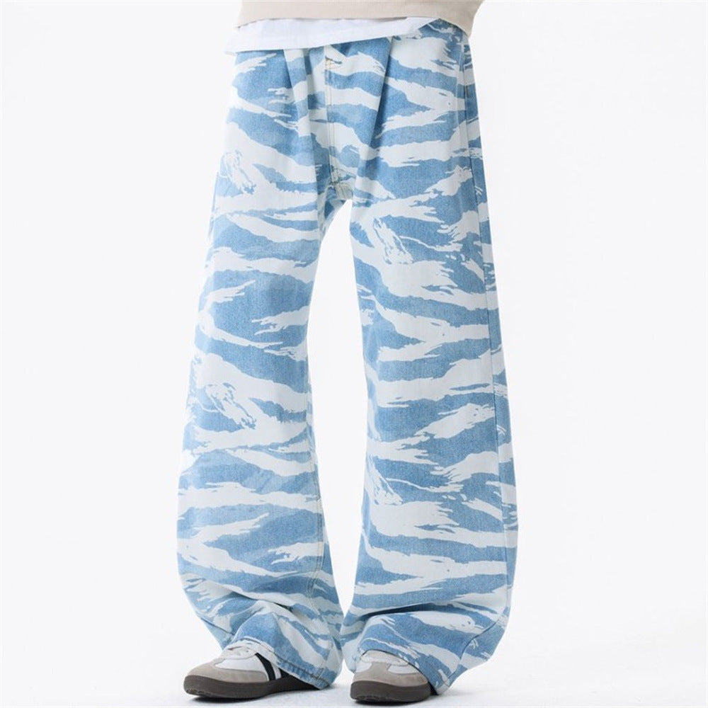 Men's baggy wide-leg jeans in sky blue zebra camouflage print with pleated waistband, front view