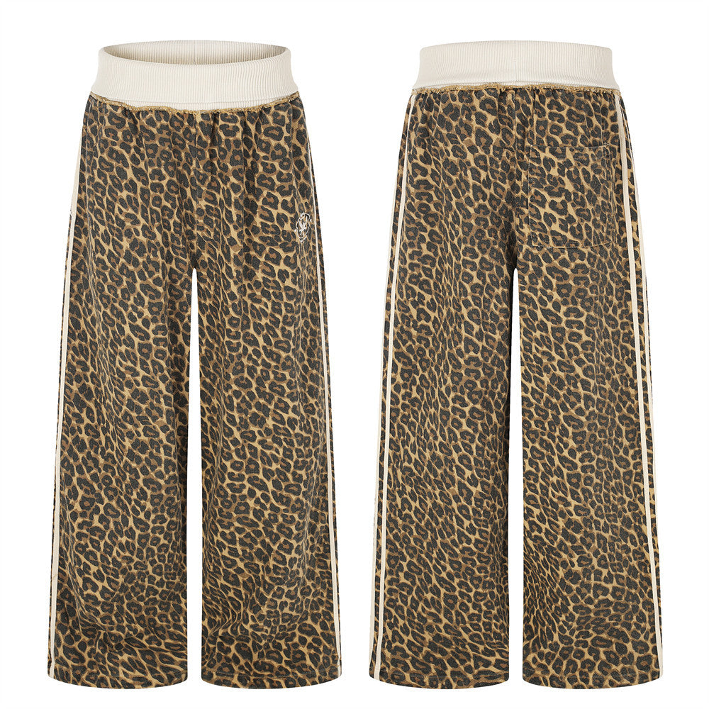 Leopard print wide-leg track pants with cream ribbed waistband and contrast side stripes, front and back view