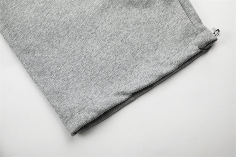 Close-up of gray sweatpants hem with subtle cuffed opening