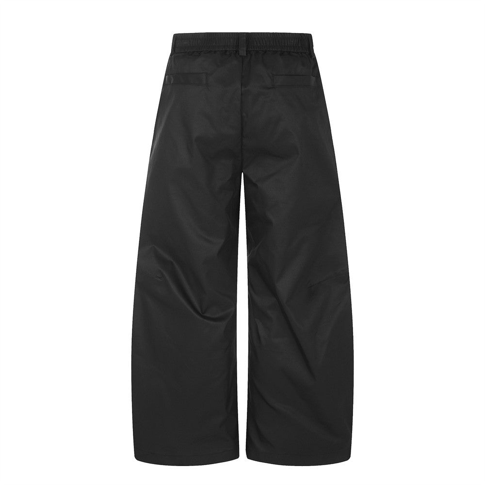 Wide-Leg Pleated Trousers – Oversized Silhouette with Curved Hem