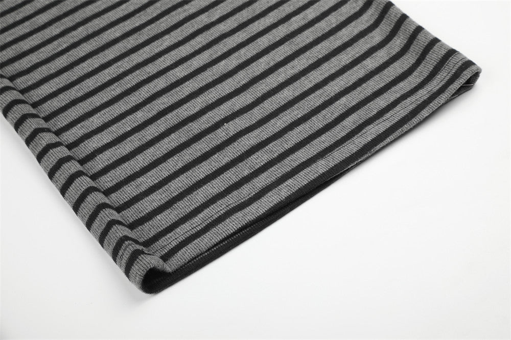 Folded hem of black and gray striped wide-leg pants, close-up detail