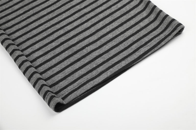 Folded hem of black and gray striped wide-leg pants, close-up detail