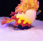 The Owl Cosplay Flame Hashira (Kyojuro Rengoku) Figure by Demon Slayer is a 11.5cm, 210g collectible showcasing vibrant yellow-red hair and a striking yellow cape. Seated on a snow-like base, he grips his sword with precision—a must-have for anime fans.