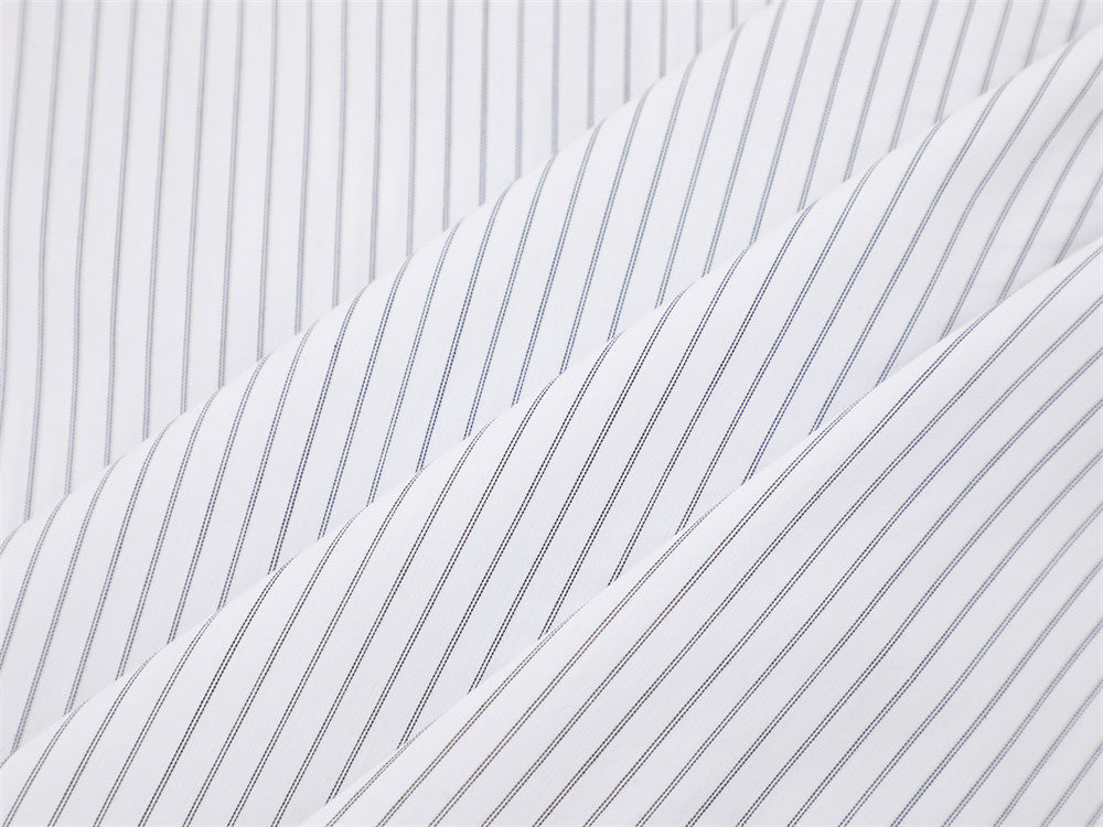 Close-up of layered white fabric with fine vertical pinstripes