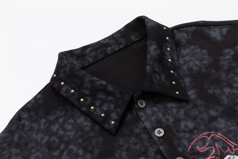 Close-up of the mottled polo collar with small gold-tone studs and visible black button placket