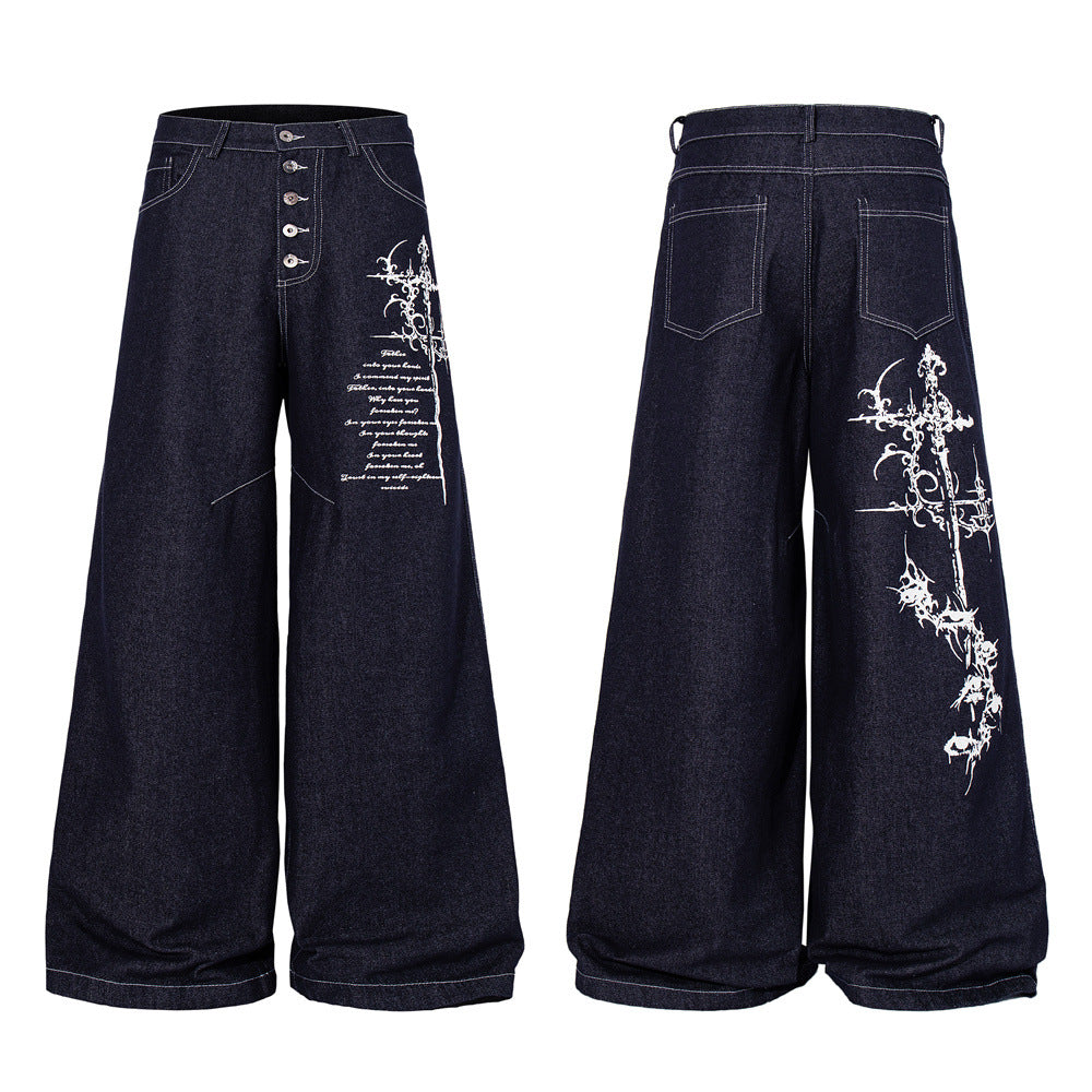 Dark indigo wide-leg jeans with gothic cross and script embroidery on the right leg, button fly closure, front and back view